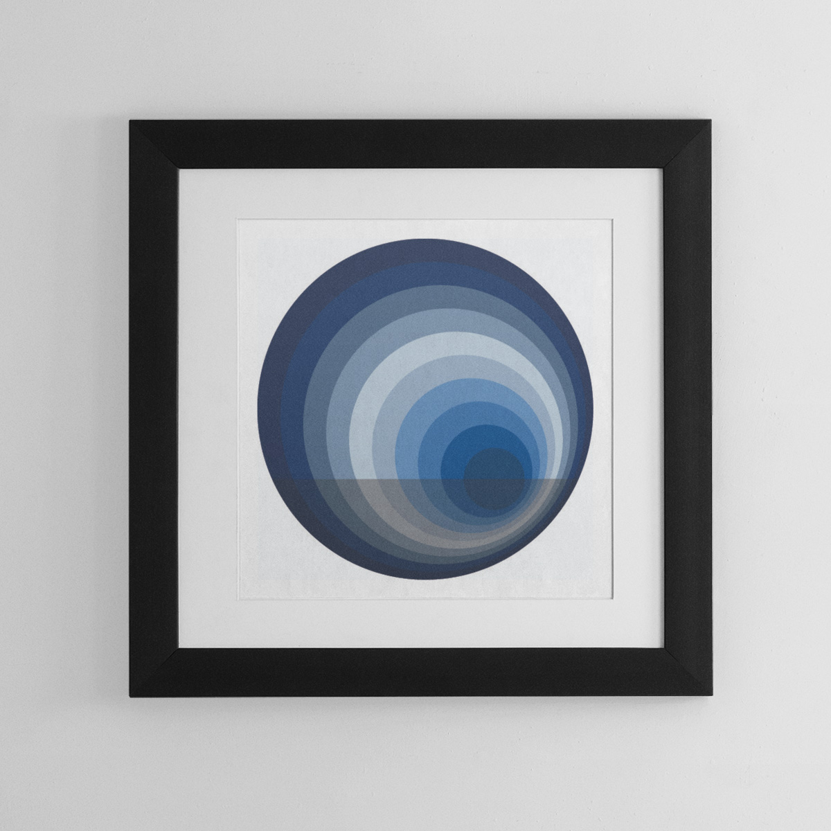 Abstract framed wall art comprised of circles in complementery shades of blue